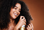 Black woman, afro and cosmetics hair spray oil for haircare wellness or natural growth treatment. African girl, luxury spa product and healthy beauty glow or hair care in brown background studio