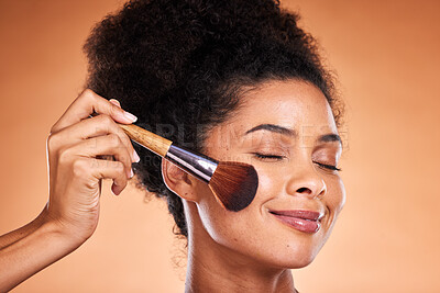 Buy stock photo Face, beauty and blusher with a black woman model in studio on a beige background to apply blush to her cheek. Makeup, cosmetics and luxury with an attractive young female using a product on her skin