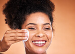 Face, skincare and black woman with cotton pad on orange studio background mockup. Happy, health and female model with product for cleaning facial makeup, cosmetics or beauty products with mock up
