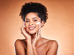 Skincare, beauty and black woman with face cream in studio for moisturizing on brown background. Portrait, smile and happy female model with facial lotion, creme or cosmetics product for healthy skin