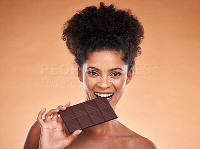 Buy stock photo Chocolate, happy woman and beauty portrait, studio background and eating sweets, cacao dessert and enjoy sugar. Black woman bite chocolate bar, cocoa and candy, diet calories and snack temptation 