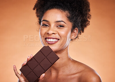 Buy stock photo Chocolate, happy woman and beauty portrait on studio background eating sweets, dessert or sugar. Young african american girl bite dark chocolate bar and cocoa candy, calories and delicious food snack