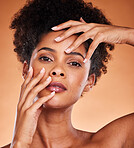 Face portrait, skincare and beauty of black woman in studio isolated on an orange background. Makeup, luxury cosmetics and female from South Africa touching skin for facial wellness and healthy skin
