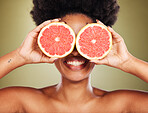 Skincare, wellness and black woman with grapefruit and smile in studio for healthy lifestyle. Beauty, creative and happy girl with fruit over eyes marketing organic, natural and fresh beauty products