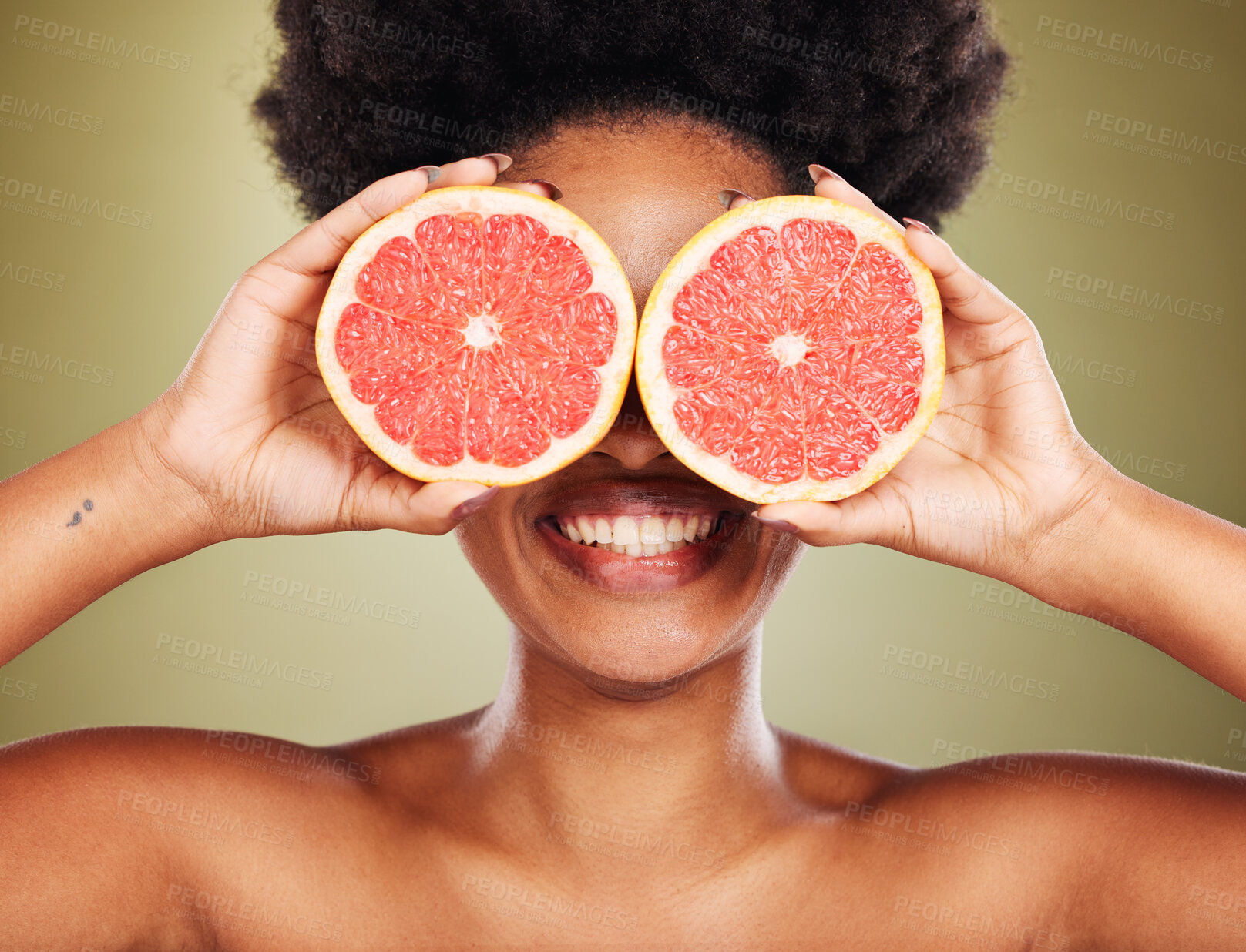 Buy stock photo Skincare, wellness and black woman with grapefruit and smile in studio for healthy lifestyle. Beauty, creative and happy girl with fruit over eyes marketing organic, natural and fresh beauty products