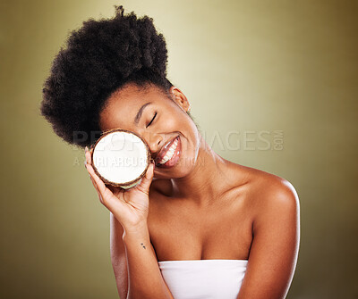 Buy stock photo Black woman, coconut and beauty in studio for skincare, health and wellness by cosmetic backdrop. Happy african model, woman or fruit for healthy glow, natural cosmetics or nutrition by background