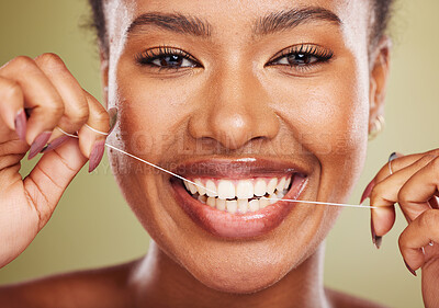Buy stock photo Black woman, teeth and smile for dental floss, skincare or cosmetic treatment against a studio background. Portrait of happy African American toothy female model flossing mouth for clean oral hygiene