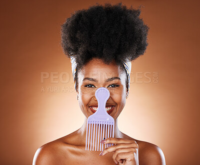 Buy stock photo Comb, black woman and hair care with smile, afro and natural beauty for health against brown studio background. Cosmetics portrait, hair product and African American female being happy, confident