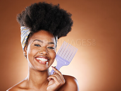 Buy stock photo Hair care, beauty and black woman with afro comb for a routine in studio with mockup space. Happy, smile and portrait of young African model with natural hair and product isolated by brown background