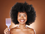 Hair care, afro and portrait of black woman with comb for wellness routine, grooming treatment or healthy hair growth. Salon, brush and face of aesthetic model with product for hairstyle maintenance
