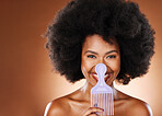 Comb, black woman and hair care with smile, happy and cosmetics for wellness, relax and with brown studio background. Portrait, African American female and girl with afro, massage scalp and grooming.