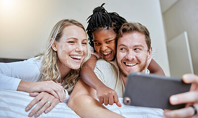 Buy stock photo Family, selfie and happiness on bed for social media profile picture or post about adoption, love and support of parents for foster child. Man, woman and girl together in bedroom with smartphone
