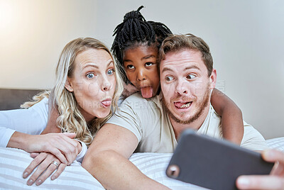 Buy stock photo Child, parents or comic face for phone selfie in house, hotel or home bedroom on social media, memory vlog or fun. Mother, father or black girl on mobile photography technology with tongue expression