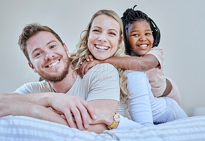 Buy stock photo Family, parents and child in interracial portrait on bed with smile, love or happy bonding together in home. Bedroom, multicultural diversity and black girl with foster mom, dad or happy family relax