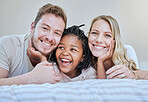 Diversity, happy family or foster parents in bedroom relax, happy or family love portrait in house or home. Mother, father and black girl with smile on bed for happiness, quality time or support
