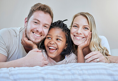 Buy stock photo Diversity, happy family or foster parents in bedroom relax, happy or family love portrait in house or home. Mother, father and black girl with smile on bed for happiness, quality time or support
