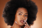 Black woman, face and skincare beauty or hair care aesthetic for cosmetics wellness. Afro, african girl and model portrait for self care makeup or skin glow dermatology in orange background studio