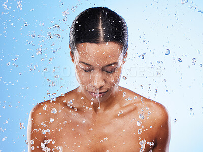 Buy stock photo Woman, water or splash with skincare for beauty, moisturizer or self care by blue background. Black woman, model and skin for cosmetics, wellness or dermatology health by cosmetic backdrop in studio