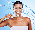 Black woman, toothbrush or smile with water splash for health skincare, wellness or dental teeth in blue studio background. Happy portrait of African girl brushing teeth for beauty or toothpaste 