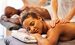 Black couple massage, spa and relax with oil on vacation, holiday or retreat together for bonding, honeymoon or calm. Black woman, man or couple in physical therapy service, health or luxury wellness