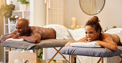 Buy stock photo Black couple, spa massage and happiness on a table for luxury, zen and relax together at a health and wellness salon. Man and woman enjoying hospitality, massage therapy and healthcare on vacation