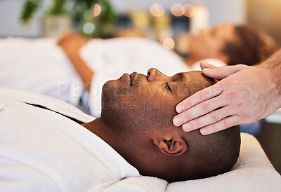 Buy stock photo Black man, relax and head massage with therapist hands in a luxury spa, wellness and skincare on a bed. Masseur with relax client in zen, calm or peace luxury hotel salon for physical body therapy