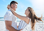 Love, beach and summer with a couple hugging on the sand by the sea or ocean while on holiday together. Happy, smile and romance with a man and woman bonding while on vacation or break by the water