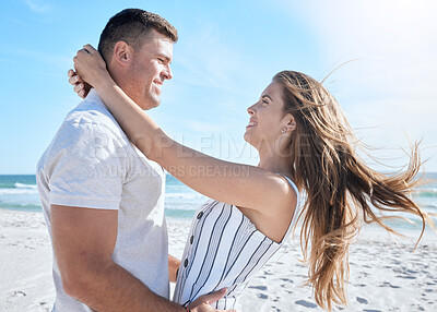 Buy stock photo Love, beach and summer with a couple hugging on the sand by the sea or ocean while on holiday together. Happy, smile and romance with a man and woman bonding while on vacation or break by the water
