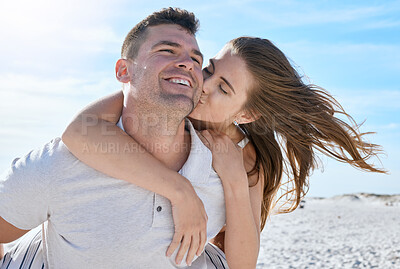 Buy stock photo Kiss, love and couple with a piggyback at the beach for travel, freedom and vacation in Mexico. Bonding, affection and young playful man and woman at the sea in nature for a date on holiday in summer