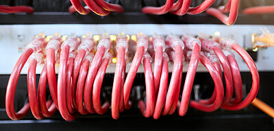 Buy stock photo Technology, server room and cables connected to ethernet port or router for network, internet or fiber in data center for connection management. Electrical red optic cable for computer it background