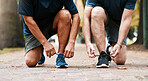 Legs, shoes and sports running team for fitness or healthcare exercise outdoors. Healthy men, teamwork training workout and marathon wellness collaboration or check trainers before run in nature park