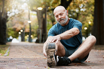 Buy stock photo Fitness, exercise and senior man stretching legs at an outdoor park for energy, health and wellness during retirement. Healthy elderly male on ground for a warm up and cardio workout in nature