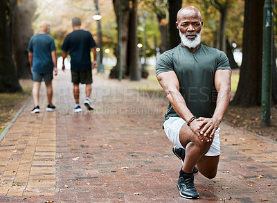 Buy stock photo Senior african man, stretching and park with focus for fitness, wellness and exercise on ground. Elderly black man, lunge and leg workout, training or muscle development in street for body health