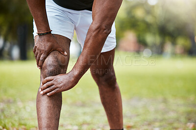 Buy stock photo Sports, fitness and knee pain of black man at park after running outdoors. Healthcare, wellness and mature male runner with leg injury, muscle pain or joint inflammation after training or workout.