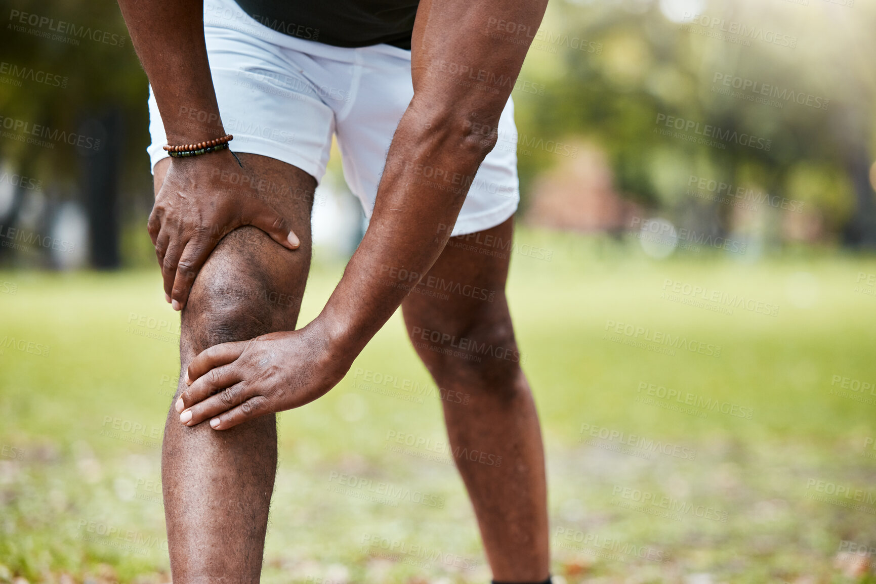 Buy stock photo Sports, fitness and knee pain of black man at park after running outdoors. Healthcare, wellness and mature male runner with leg injury, muscle pain or joint inflammation after training or workout.