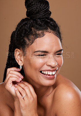 Buy stock photo Makeup, marketing and woman laughing for cosmetics, skincare and self care against a brown studio background. Relax, comic and model with comedy from beauty, dermatology and advertising of body glow