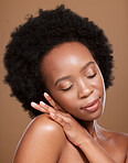 Black woman afro, skincare and face with smile for cosmetics, beauty or makeup against a brown studio background. African American female relax in wellness for luxury facial, hair or skin treatment
