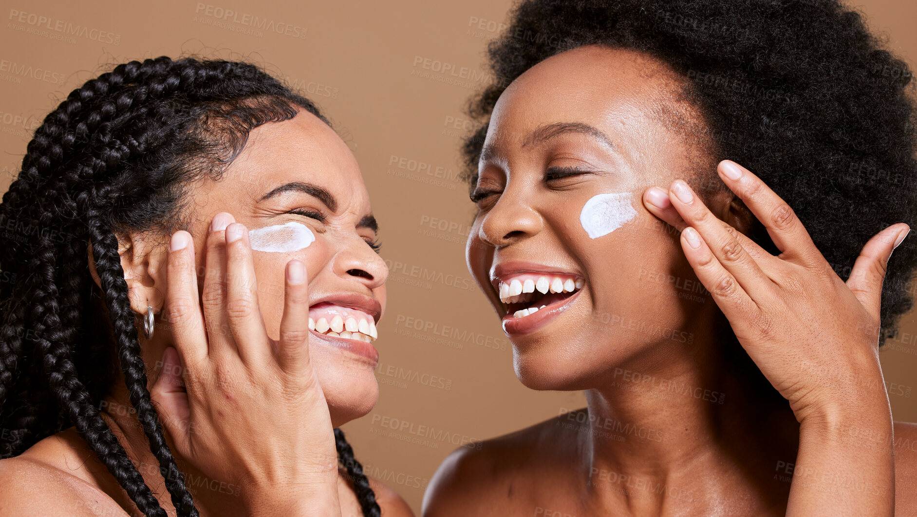 Buy stock photo Black woman, cream and skincare with friends support, love and beauty together in studio for cosmetics, makeup cleaning and facial. Excited, diversity model with sunscreen or essential oil on face