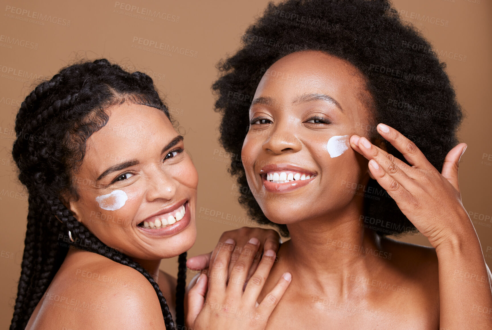 Buy stock photo Beauty, friends and black women with face cream for skincare or moisturizing in studio on brown background. Smile, group portrait and models apply facial product or cosmetics creme for healthy skin.
