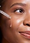 Black woman, dropper and facial skincare cosmetics for beauty, hydration or oil treatment for healthy face. Closeup of African American female applying serum to cheek for skin hydrate, glow or shine