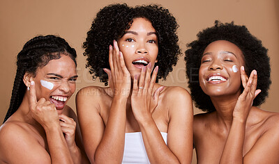 Buy stock photo Skincare, beauty and black women, friends and face cream in studio on brown background. Group portrait, smile and happy models apply facial lotion or cosmetics product for moisturizing healthy skin.
