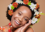 Beauty, art and black woman with flower crown in hair and smile on face, portrait with studio background. Nature, happy woman with flowers, natural skincare or hair care with sustainable ingredients.