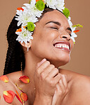 Beauty, skincare and flowers in hair of black woman for self love, natural and spring season. Luxury, happy and fresh with girl model and petals for style, fashion and creative in studio background 