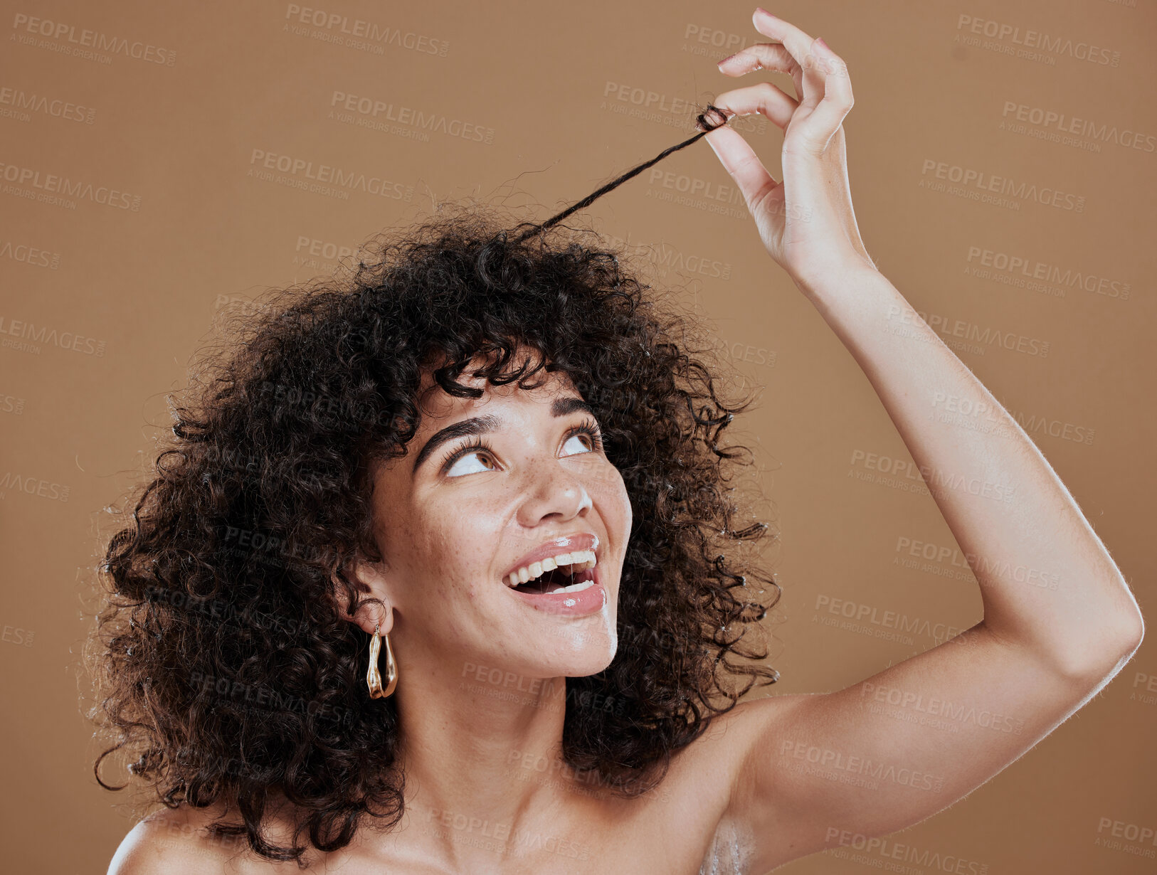 Buy stock photo Hair care, beauty and happy woman with afro in a studio for a health, clean and curly treatment. Wellness, hair style and young model holding strand of natural hair while isolated by brown background