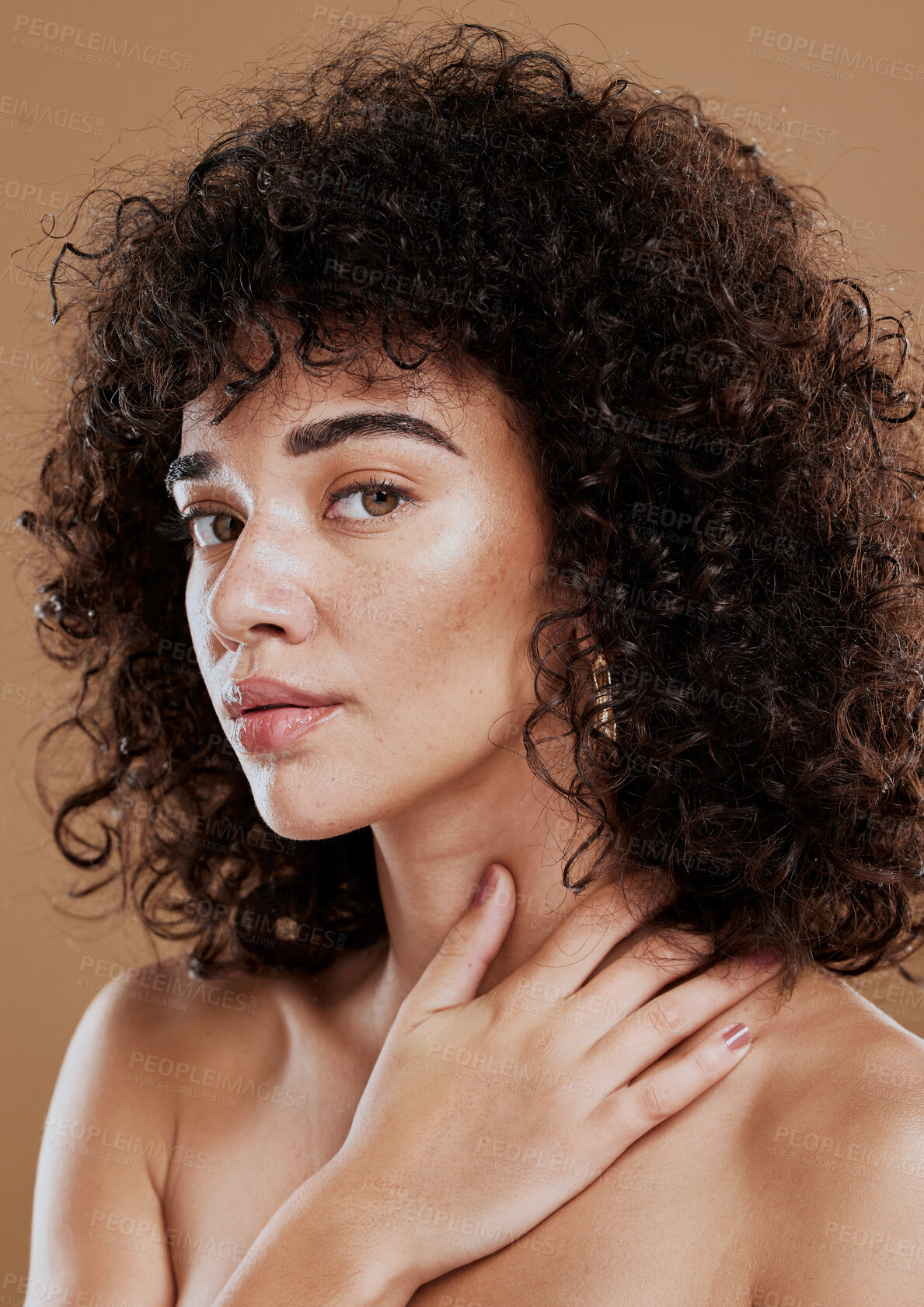 Buy stock photo Face, beauty and skincare with a model black woman in studio on a brown background for natural hair care. Eyes, portrait and makeup with an attractive young female posing to promote cosmetics