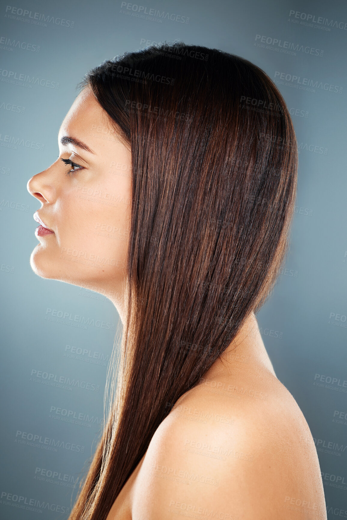 Buy stock photo Hair care, brunette and side profile of a woman with salon straight hair against a blue studio background. Wellness, beauty and face of a model with shine, clean and healthy hair with a backdrop