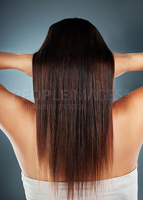 Buy stock photo Hair, beauty and keratin treatment with a model woman in studio on a blue background for wellness or haircare. Head, product and salon with a female posing to promote nature haircare from the back