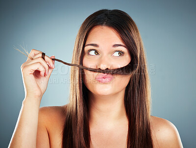 Buy stock photo Woman, hair and face of a female with a braid and silly face expression for haircare on a grey studio background. Beauty, cosmetology and brunette with a hair moustache for comic face with hairstyle 