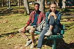 Adventure, travel and interracial couple in a park for vacation, relax and date together in Indonesia. Nature, sad and black man and woman on a bench in a field during a holiday after marriage