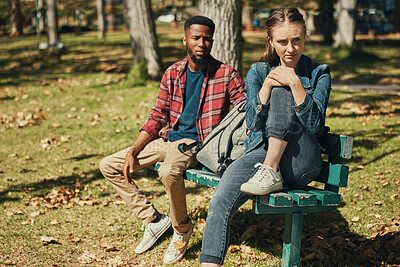 Buy stock photo Angry, fight and interracial couple in conflict in a park with stress about divorce, mental health and marriage fail. Depression, sad and black man and woman frustrated with a problem in nature